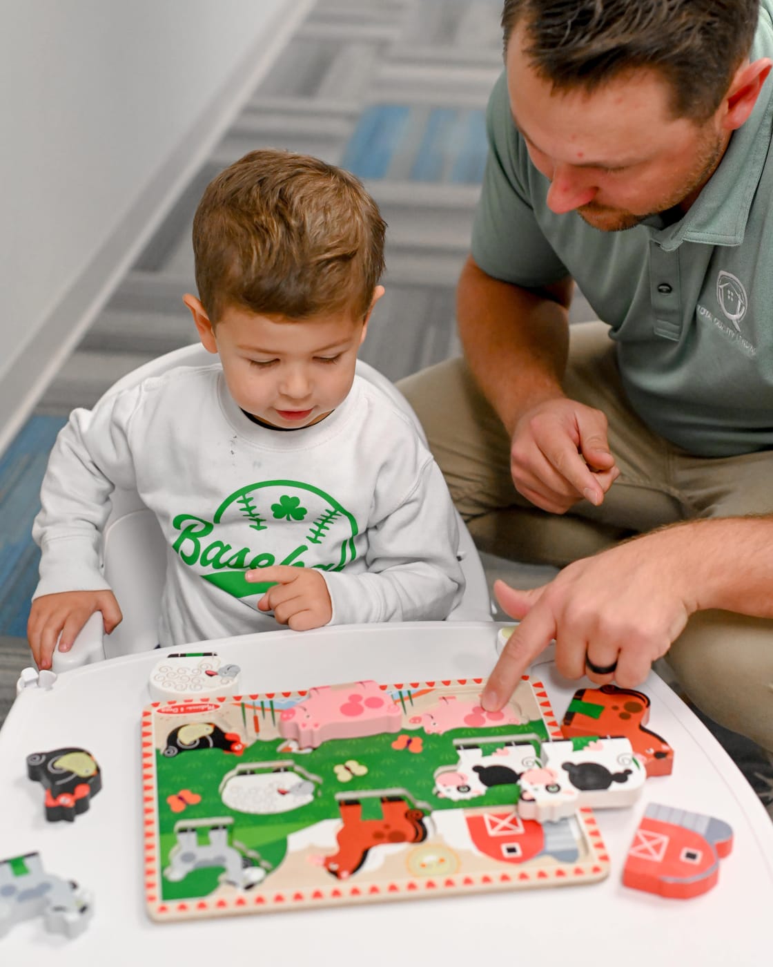 Father and son sitting together at home, working through a puzzle — Total Quality Lending family-first approach